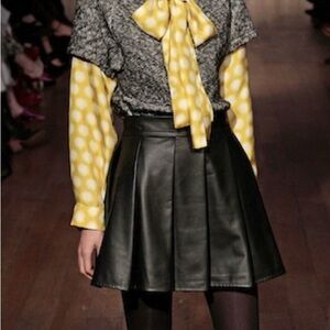 WHIT Black leather pleated mini skirt.